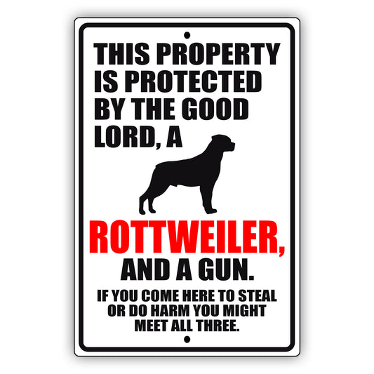 This property is protected by the good lord a rottweiler and a gun aluminum metal sign