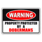Warning property protected by a dobermans aluminum metal sign