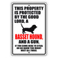 This property is protected by the good lord a basset hound and a gun aluminum metal sign