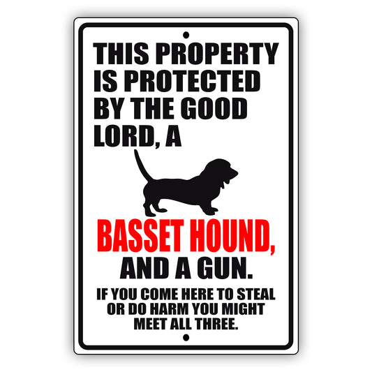 This property is protected by the good lord a basset hound and a gun aluminum metal sign