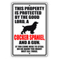 This property is protected by the good lord a cocker spaniel and a gun aluminum metal sign