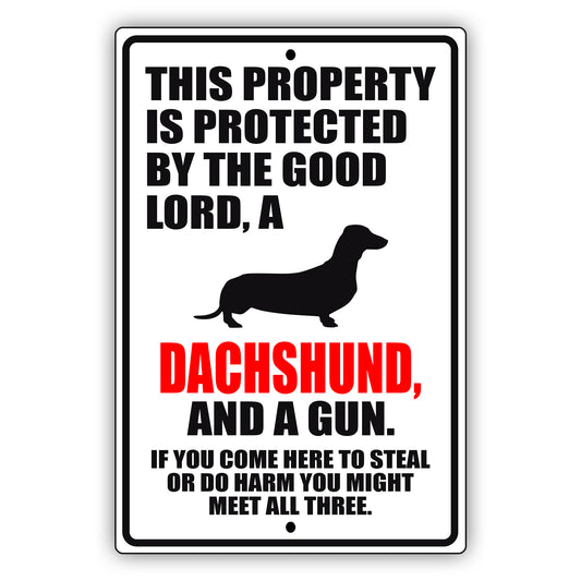 This property is protected by the good lord a dachshund and a gun aluminum metal sign