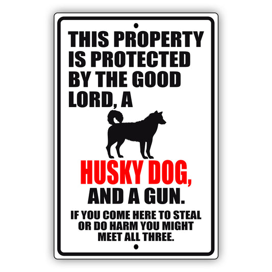 This property is protected by the good lord a husky dog and a gun aluminum metal sign