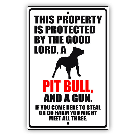 This property is protected by the good lord a pit bull and a gun aluminum metal sign