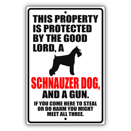 This property is protected by the good lord a schnauzer dog and a gun aluminum metal sign