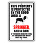 This property is protected by the good lord a springer and a gun aluminum metal sign