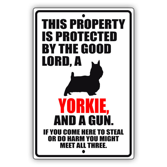 This property is protected by the good lord a yorkie and a gun aluminum metal sign